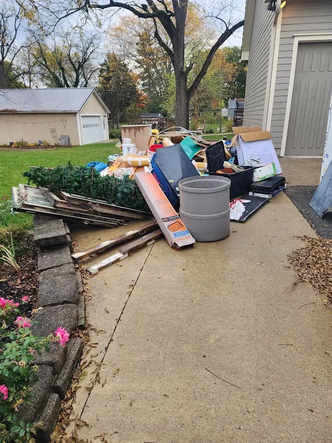 Dumpster being loaded with debris for 12 Yard Dumpster Rental in Granite City